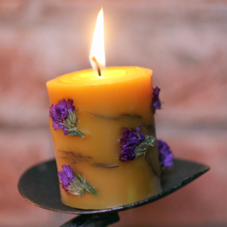 Beeswax pillar candles with flower ornaments